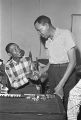 Willie Harris shaking hands with William "Baby Boy" Harris at Tom's Place at 648 South Holt Street in Montgomery, Alabama.