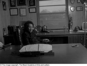 Photograph of Tiny Hawkins seated in her office