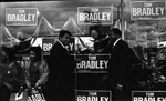 Muhammad Ali pointing to Tom Bradley outside of a campaign office, Los Angeles, 1981