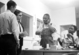 Roosevelt Barnett speaking on a phone in an office, possibly the headquarters of the SCLC in Montgomery, Alabama.