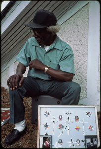 Outsider art: Theodore Hill. Theodore Hill with one of his visual art pieces