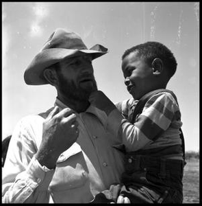 Jack Newcomb Holding a Boy