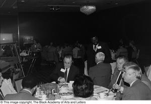 Photograph of a dining area, in which two televisions are set up