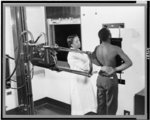 [Nurse placing patient in the correct position for taking a chest X-ray for use in the diagnosis of tuberculosis at the Southwest health center]