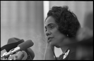 Coretta Scott King addressing the Solidarity Day crowd at the Poor People's March on Washington, speaking against the War in Vietnam Portrait in profile, at the microphones