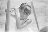 Dannice Simon on a playground during a cookout in the Madison Park community in Montgomery, Alabama.