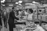 Governor Albert Brewer shaking hands with an employee during a tour at the Simon & Mogilner garment factory in Birmingham, Alabama.