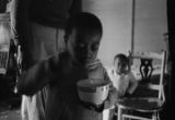 Young boy of the Turner family in Montgomery, Alabama, eating out of a bowl.