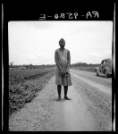 [Untitled photo, possibly related to: Negro woman carrying her shoes home from church. Mississippi Delta]