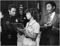 Police Chief George Napper presenting a plaque in remembrance of a fallen officer, 1980