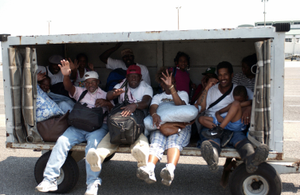 Airport luggage carriers are employed as a means to transport evacuees to the main passenger terminal at the Louis Armstrong International Airport, in New Orleans, Louisiana (LA), as rescue efforts are underway in the aftermath of Hurricane Katrina