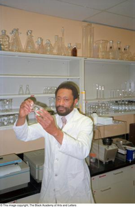 Photograph of Dr. Edison Fowlks holding a Erlenmeyer flask