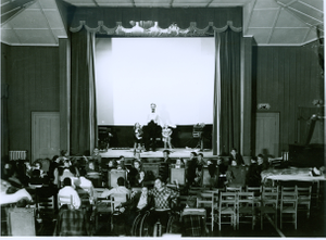 Thumbnail for Photograph of Georgia Warm Springs Foundation patients and staff watching a live performance on the playhouse stage at the Georgia Warm Springs Foundation, Warm Springs, Meriwether County, Georgia, 1930-1940?