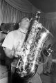 Bobby Moore playing the saxophone on stage at the Laicos Club in Montgomery, Alabama, during a performance by his group, Bobby Moore and the Rhythm Aces.