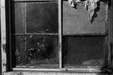 Little boy looking out the window of a house in Newtown, a neighborhood in Montgomery, Alabama.