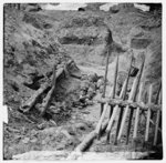 [Petersburg, Va. Dead Confederate soldier, in trench beyond a section of chevaux-de-frise]