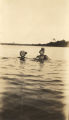 Two young African American women swimming.