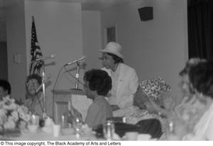 Woman standing at podium to address the crowd