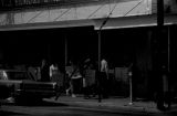 Protestors carrying signs while marching past the V. J. Elmore store in downtown Prattville, Alabama, during a civil rights demonstration.