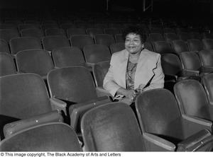 Dr. Versia Lacy seated in empty auditorium