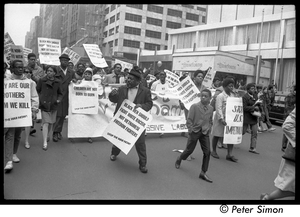 Harlem Peace March: Progressive Labor Party march behind banner reading 'Get out of Vietnam now' African American antiwar protesters marching through the New York streets, signs reading 'Black men should fight white racism, not Vietnamese freedom fighters'