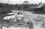 Thumbnail for Man driving a tractor down a dirt road near Mount Meigs in Montgomery County, Alabama.