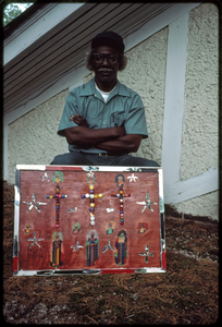 Outsider art: Theodore Hill. Theodore Hill with one of his visual art pieces