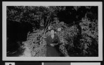 Charlotte Bass in a garden, circa 1941/1950