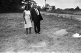 Dr. and Mrs. H. D. Monteith Inspect a Bomb Crater