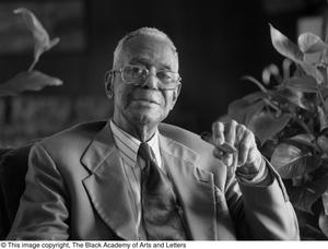 Arthur A. Braswell sitting and smoking a cigar