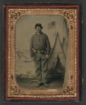 [Unidentified soldier in Union uniform with revolver in holster in front of U.S. Picture Tent painted backdrop]