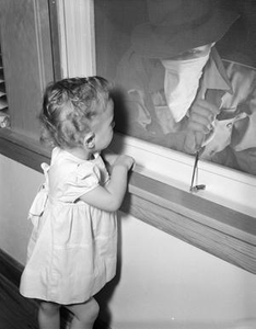 Burglar Attempting to Enter a Home as a Girl Watches