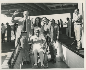 Group waves at camera on gangplank