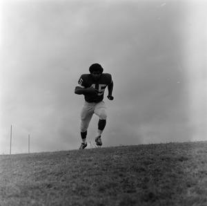 Football player running with the ball, 35