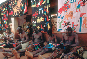 Appliqué workers, in street, Abomey, Benin