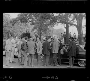 Reporters and photographers standing near cars at Black student rally in Franklin Park