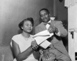 Autherine Lucy and Arthur Shores reading correspondence (possibly her acceptance letter) from the Office of Admissions and Records at the University of Alabama.