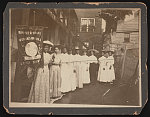 [Nine African-American women posed, standing, full length, with Nannie Burroughs holding banner reading, "Banner State Woman's National Baptist Convention"]