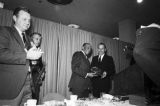 Governor Albert Brewer presenting a plaque to Jesse Owens during the induction ceremony for the Alabama Sports Hall of Fame in Birmingham, Alabama.