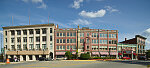 Block in downtown Woonsocket, Rhode Island, that includes the Stadium Theatre (short green building) and, to its left, the Stadium office building