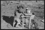 Children of Negro sharecropper pumping water. Family will be resettled at Transylvania Project, Louisiana