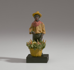 Wax figurine of a caricatured vegetable vendor