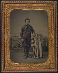 [Unidentified young sailor in Union uniform in front of painted backdrop showing ship interior with sea beyond]