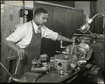 African American student in machine shop at lathe - 1950s