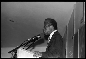 James Baldwin lecturing at UMass Amherst Baldwin standing at a podium with microphones