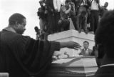 Ralph Abernathy at the casket of Martin Luther King, Jr. at South View Cemetery.