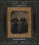 [Unidentified sailors in Union uniforms with American flag in front of painted backdrop showing ship deck with Monitor class ship in the distance]