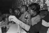 People seated at a table in a club, probably in Montgomery, Alabama.