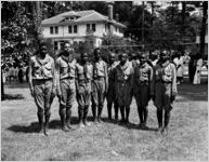 Celebrations around the awarding of a 1943 Army Navy E Award to the Avondale Mills, Sylacauga, Alabama. In this photograph, a group of eight young African-American scouts pose