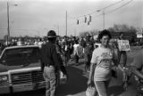 Alabama state trooper observing marchers during the 20th anniversary reenactment of the Selma to Montgomery March in Selma, Alabama.